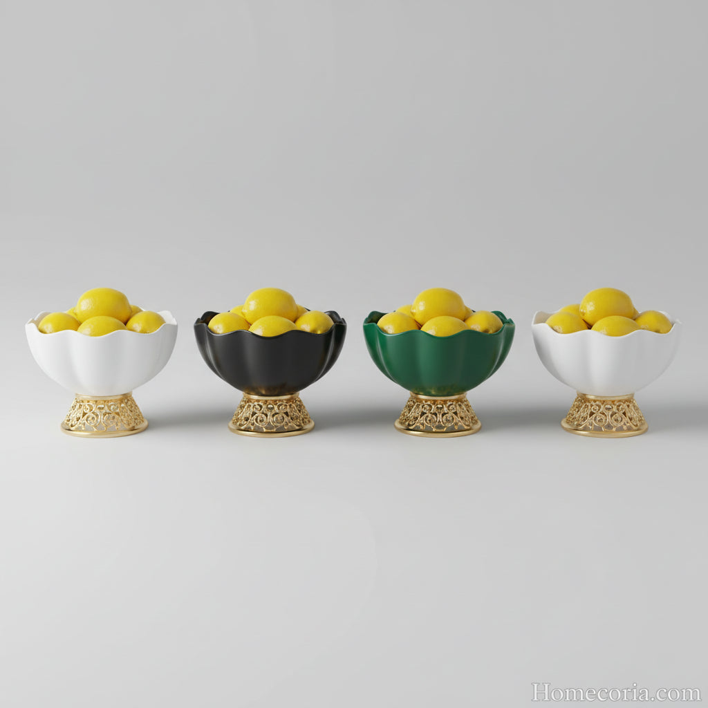 Set of decorative fruit bowls with gold and black bases on a gray background.
