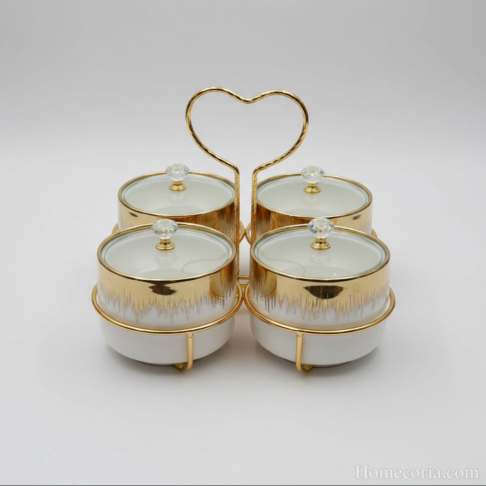 Set of ceramic canisters with gold accents in front of a packaging box on a tiled floor.
